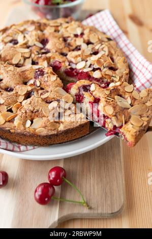 Cherry pie with almonds on wooden table. Baked with fresh sour cherries Stock Photo