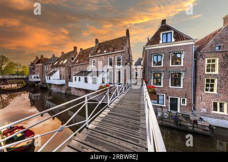 Famous medieval 'hanging kitchens' over the Damsterdiep in the historic town of Appingedam under spectacular sky, Groningen, Holland. Stock Photo