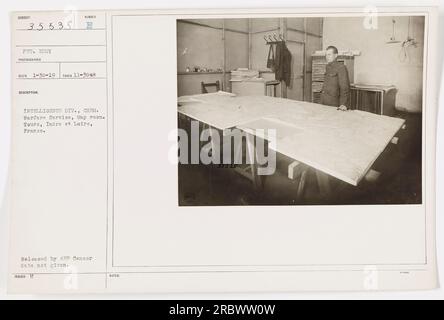 'Private Eddy, a photographer with the Intelligence Division of the Chemical Warfare Service, is photographed in the map room in Tours, Indre et Loire, France. This photograph was released by the AEP Censor, although the exact date of release is unknown.' Stock Photo