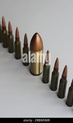 Inclusion And Diversity. Row of same bullets with one big bullet lined out isolated on white Stock Photo