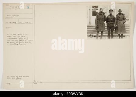 Captions: - American military officers Capt. H. L. Dunn, 1st Lt. John C. Zimmerman, and Capt. R. B. Woolverton at Toul, Meurthe et Moselle, France during World War One. - Sgt. Loiters, photographer for the army, captures the image on November 18, 1918. - The three officers are identified from left to right as Capt. H. L. Dunn, 1st Lt. John C. Zimmerman, and Capt. R. B. Woolverton. Stock Photo