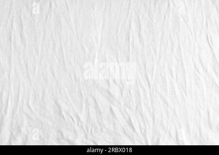 Wrinkled, crumpled white fabric texture background. Wrinkled and creased abstract backdrop of cotton jersey textile, wallpaper with copy space, top vi Stock Photo