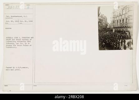 General John J. Pershing and his staff are seen reviewing the 18th Infantry, 1st Division as they pass the Grand Palace in Luxembourg. This photograph was taken on November 21, 1918, during World War One. The specific date of issue is unknown. Stock Photo