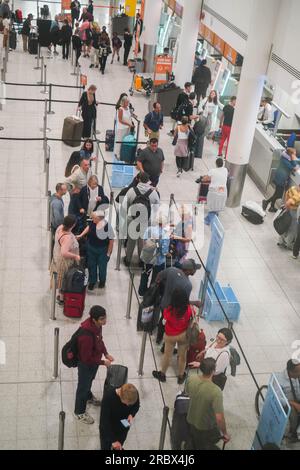 London UK. 11 July 2023   Passengers at Easyjet check in at Gatwick airport. The low budget airline has EasyJet  has cancelled 1,700 summer flights affecting  180,000 passengers which has been  blamed on air-traffic control. Credit amer ghazzal/Alamy Live News Stock Photo