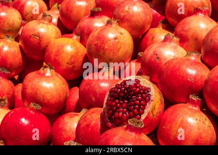 Pile of pomegranate fruit at street market Stock Photo