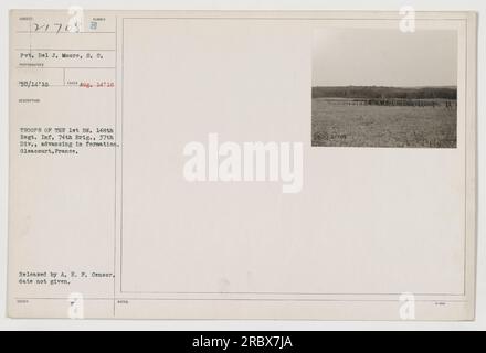 Troops of the 1st Battalion, 148th Regiment, Infantry, 74th Brigade, 37th Division, are seen advancing in formation in Gleacourt, France. This photograph, taken on August 14, 1918, depicts Pvt. Del J. Moore among them. It was issued by the Military Intelligence Section of the American Expeditionary Forces (A.E.F.). The exact date of release by the A.E.F. Censor is not provided. Stock Photo