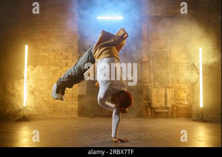 Male street artist b-boying performing breakdancing active training Stock Photo