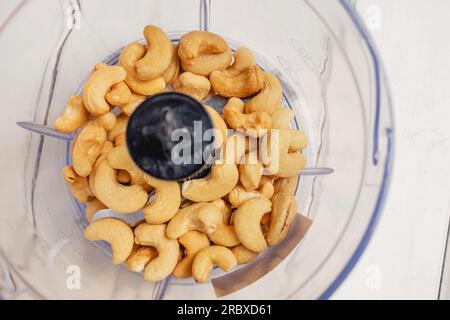 Cashew nuts in a blender close-up, making vegan cheese alternative Stock Photo