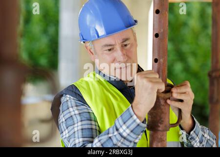 mature worker repairing the water pipe Stock Photo