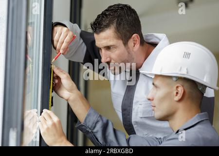male hands making window measurements Stock Photo