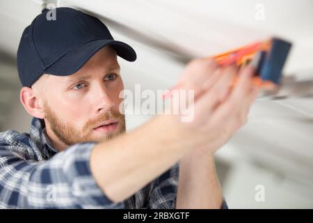 workman using a spirit level Stock Photo