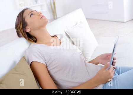 woman on the sofa with tablet Stock Photo