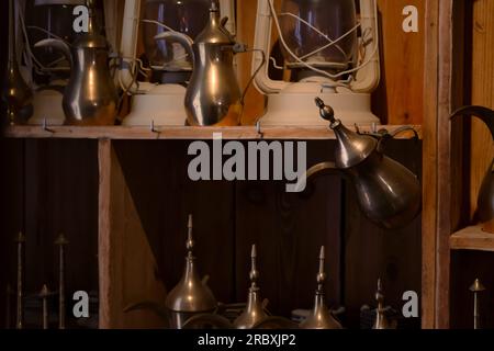 Traditional Arabic coffee pots om wooden shelfs. Stock Photo