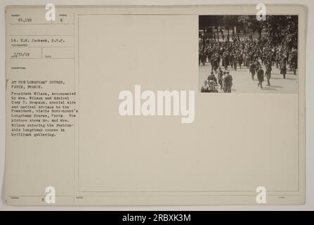 President Wilson, accompanied by his wife and Admiral Cary T. Grayson, visits the Government's Longchamp Course in Paris, France. The photograph captures the moment as Mr. and Mrs. Wilson enter the fashionable venue surrounded by a vibrant crowd. The date of the photograph is July 31, 1919. Stock Photo