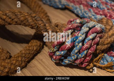 Close up of rope with twines going out and two textured fabrics wrapped around. Stock Photo