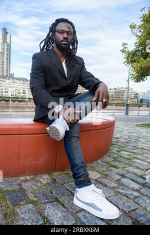 Young African Man With Dreadlocks Wearing Business Jacket Over White 