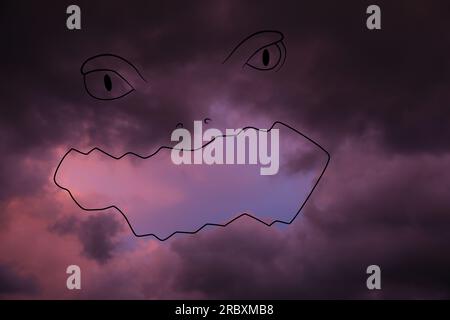 Imagination and creativity. Fluffy cloud resembling scary face in sky, drawn outline Stock Photo