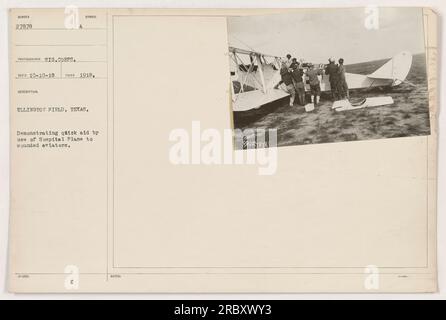 This photograph taken in 1918 at Ellington Field in Texas shows a demonstration of quick aid to wounded aviators using a hospital plane. It is part of a collection of photographs documenting American military activities during World War One. Stock Photo