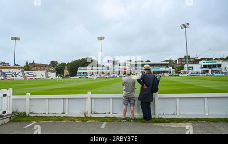 Hove UK 11th July 2023 -  Spectators watch Sussex take on Derbyshire in gloomy conditionsduring day two of the LV= Insurance County Championship cricket match at the 1st Central County Ground in Hove : Credit Simon Dack /TPI/ Alamy Live News Stock Photo