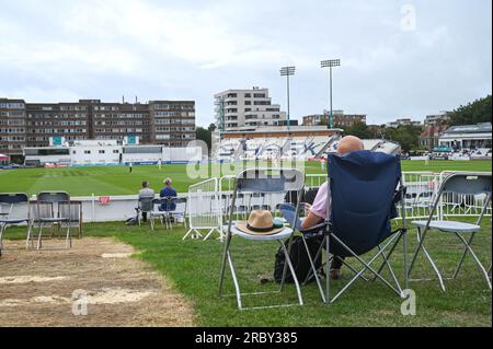 Hove UK 11th July 2023 -  Spectators watch Sussex take on Derbyshire in gloomy conditionsduring day two of the LV= Insurance County Championship cricket match at the 1st Central County Ground in Hove : Credit Simon Dack /TPI/ Alamy Live News Stock Photo