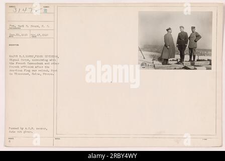 Title: 'Major E.J. Hardy conversing with French officers after the American flag was raised at Fort de Vincennes, Seine, France' Caption: 'Major E.J. Hardy, from the Signal Corps' Photo Division, discusses matters with the French Commandant and other French officers at Fort de Vincennes. This photograph was taken on November 13, 1918, after the American flag was raised. It was authorized and passed by the A.E.F. censor.' Stock Photo