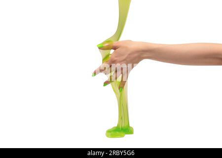 Green slime toy in woman hand with green nails isolated on a white background. Stock Photo