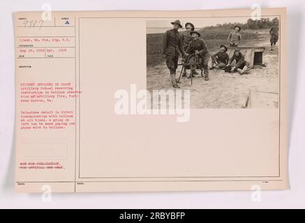 Student officers at the Coast Artillery School in Fortress Monroe, Va., are receiving instruction in balloon observation of artillery fire during World War One. A telephone detail ensures direct communication with the balloon at all times, and a group on the left is seen paying out wire to the balloon. Stock Photo