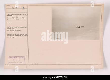 Title: Aviation Cadets Training at Kelly Field, San Antonio, Texas Caption: A group of aviation cadets at Kelly Field engaged in advanced solo maneuvers and testing in the air. The image shows planes soaring through the sky, following a carefully planned training program. This photograph was taken in May 1918 and was approved for release on May 20, 1918, by the Historical Branch, W.P.D. (War Plans Division). Stock Photo