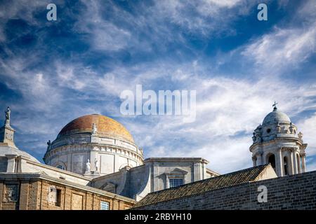 Roof of the cathedral of Cadiz, Andalusia, Spain, with the tower and golden dome as protagonists and blue sky Stock Photo