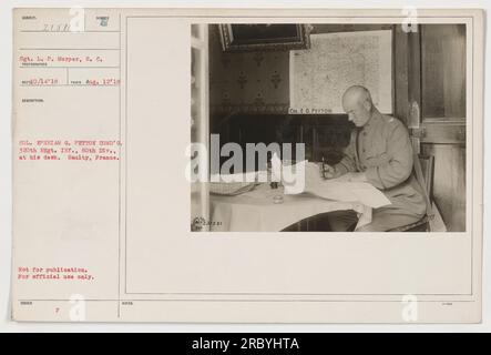 Colonel E. G. Peyton, Commander of the 320th Regiment Infantry, 80th Division, is pictured here at his desk in Saulty, France. This photograph was taken by Sgt. L. P. Morper of the Signal Corps on August 12, 1918. It is not intended for publication and is for official use only. Stock Photo