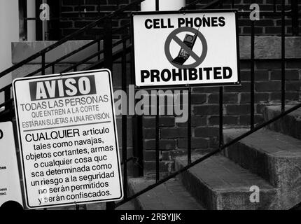 Signs in English and Spanish posted near a courthouse entrance in Abingdon, Virginia, USA. Stock Photo