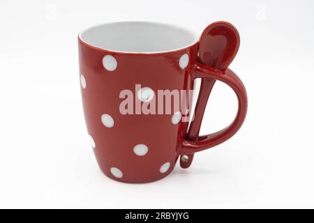 Red polka dot mug with spoon Stock Photo