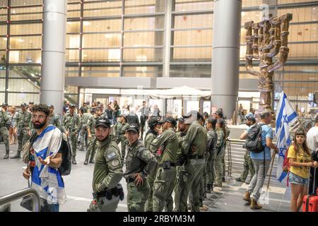 Israeli border police soldiers stand on guard during a demonstration against the judicial overhaul in Ben Gurion Airport. Stock Photo