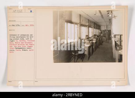 Interior view of the assembling and filing departments for moving picture work at the Signal Corps Photographic Laboratory in Paris, France during World War I. Pictured from left to right: Lieutenant Griffin, Privates Holt, Walker, and Moissant, Privates Guetlein and Timer, and Sergeant Van Dwer Veer. Captured in April 1918. Stock Photo