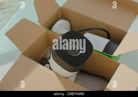 Close-up of new, modern security cameras, still in their packaging. High quality surveillance and protection concept. Stock Photo