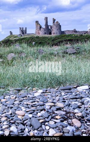 Dunstanburgh Castle, Northumberland  is a 14th-century fortification on the coast of Northumberland in northern England. Stock Photo