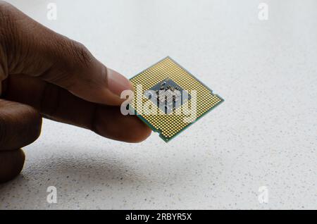 Detailed close-up of a hand holding a powerful computer processor, representing technological excellence. Stock Photo