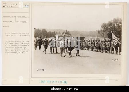 French Commissioner Colonel de Billy salutes the American flag while reviewing the US troops at Camp Presidio, California. The photograph was taken in 1917 as part of the French Mission's visit to the US. This image is issued as document 031009 with reference to CO 64019. Stock Photo