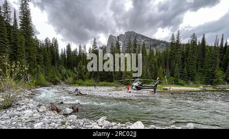 Moran, United States Of America. 24th June, 2022. Moran, United States of America. 24 June, 2022. A private helicopter illegally lands at Moran Bay on the west shore of Jackson Lake, June 24, 2023 in Grand Teton National Park, Wyoming. Park Rangers responded and found the pilot Peter Smith, of Gunnison, Colorado, and a companion picnicking along the lake. Landing private aircraft inside a national park is illegal and subject to fines and suspension of the pilots license. Credit: NPS Photo/National Park Service/Alamy Live News Stock Photo