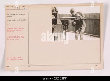 Officers at the anti-aircraft gun school at Fortress Monroe, Virginia, practice using a universal sight that moves in all directions. Lt. William Fox, a signal officer, is pictured in this photo taken in April 1918. This photograph is classified as not for publication and for official use only. Stock Photo