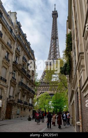 Cozy street with view of Paris Eiffel Tower in Paris, France. Eiffel Tower is one of the most iconic landmarks in Paris. Architecture and landmark of Stock Photo