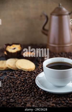 Coffee with coffee beans and biscuits Stock Photo
