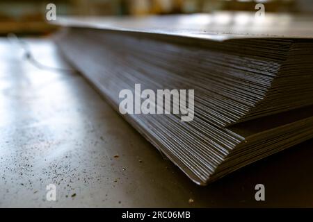 a stack of galvanized thin hot rolled steel sheets in a warehouse Stock Photo