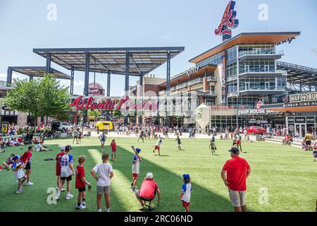 Atlanta Georgia,The Battery Atlanta Truist Park stadium,mixed use development Braves baseball team home,boys playing Stock Photo