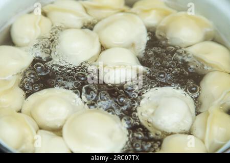 Dumplings or pelmeni boil in a pot. View from above. Stock Photo