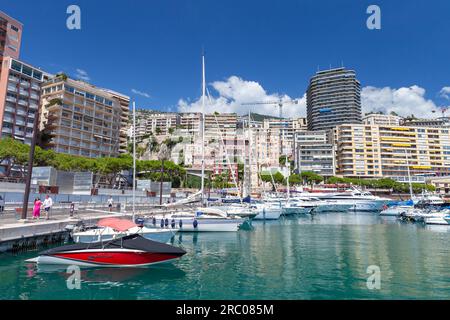 Monte Carlo, Monaco - August 15, 2018: Port Hercule view on a sunny summer day. Yachts and pleasure boats are moored in marina, tourists walk the stre Stock Photo