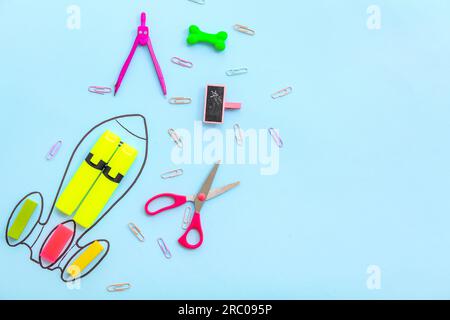 Creative composition with drawn rocket and different stationery on blue background Stock Photo