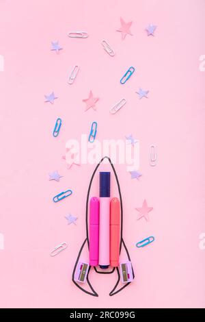 Creative composition with drawn rocket and different stationery on pink background Stock Photo