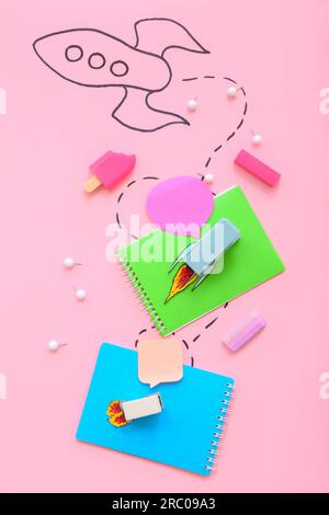 Creative composition with drawn rocket and different stationery on pink background Stock Photo