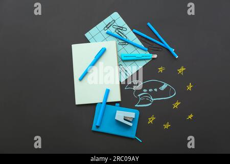 Creative composition with drawn rocket and different stationery on black chalkboard Stock Photo